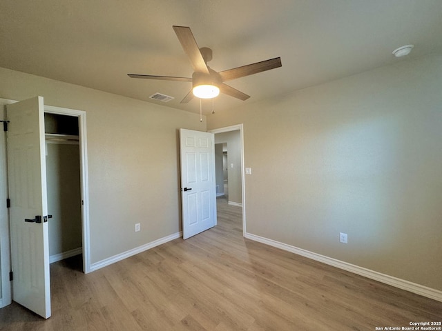 unfurnished bedroom featuring light wood finished floors, visible vents, baseboards, a closet, and a ceiling fan