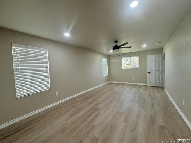 spare room with visible vents, baseboards, recessed lighting, light wood-style floors, and a ceiling fan