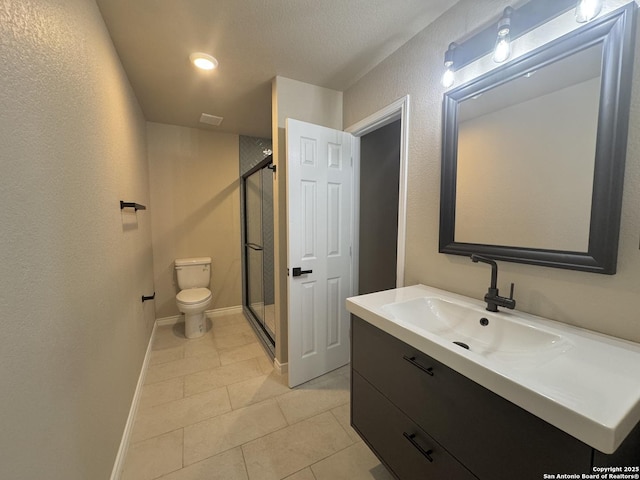 full bath featuring tile patterned flooring, a shower stall, baseboards, toilet, and vanity