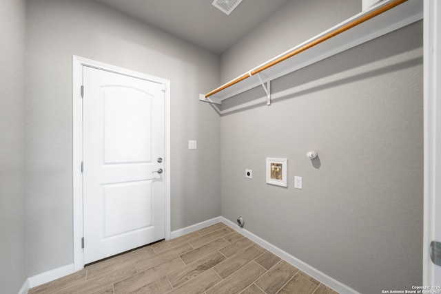 clothes washing area featuring electric dryer hookup, laundry area, gas dryer hookup, hookup for a washing machine, and wood tiled floor