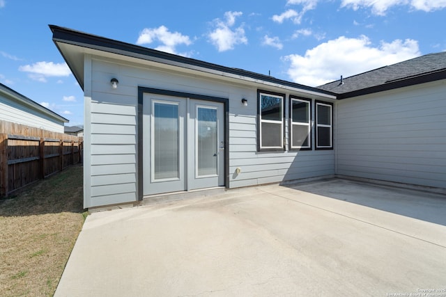 rear view of property with a patio, fence, and a lawn