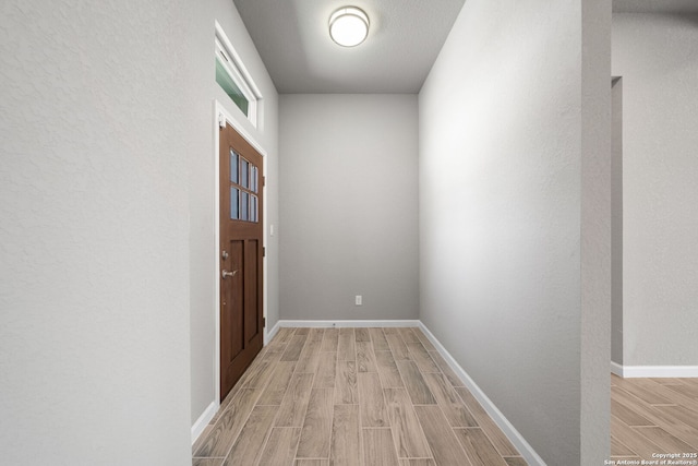 entryway featuring wood finish floors and baseboards