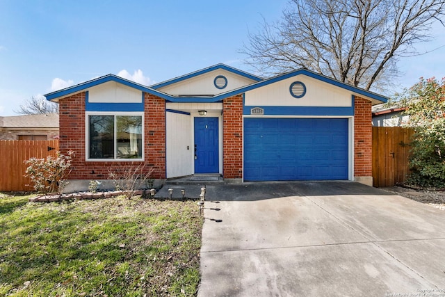 view of front of house with a garage, brick siding, concrete driveway, and fence