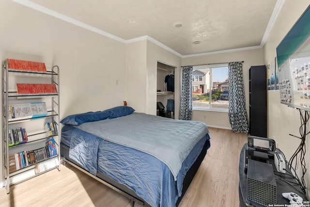 bedroom featuring ornamental molding, baseboards, and wood finished floors