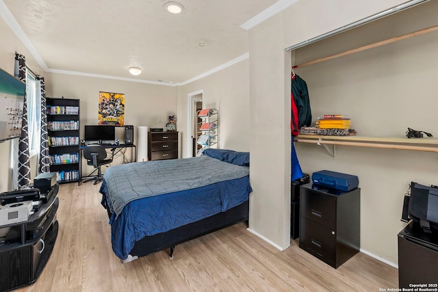 bedroom featuring ornamental molding, baseboards, and wood finished floors