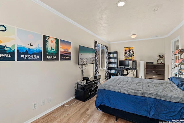 bedroom featuring baseboards, wood finished floors, visible vents, and ornamental molding