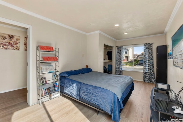 bedroom with recessed lighting, crown molding, baseboards, and wood finished floors