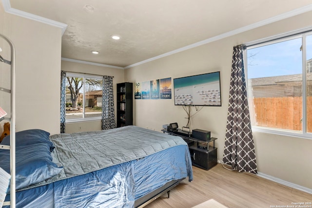 bedroom featuring recessed lighting, wood finished floors, baseboards, and ornamental molding