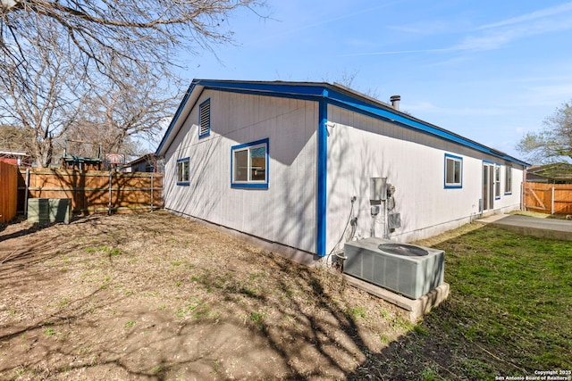 back of house with cooling unit and fence