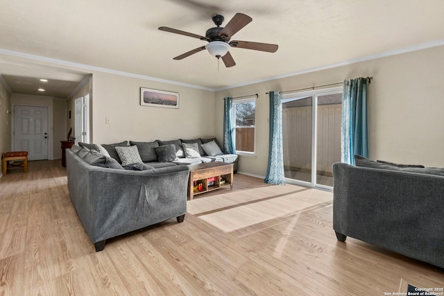 living room with crown molding, light wood-style floors, and ceiling fan