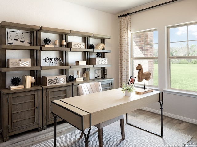 office with plenty of natural light, baseboards, and wood finished floors