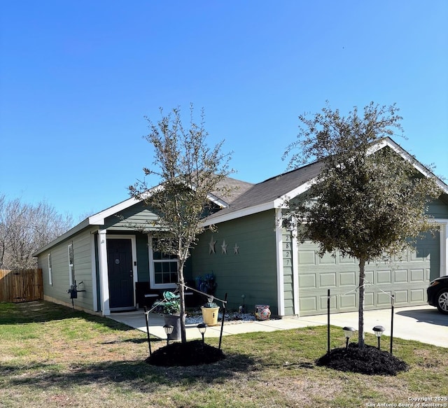 ranch-style home with a front yard, fence, and driveway