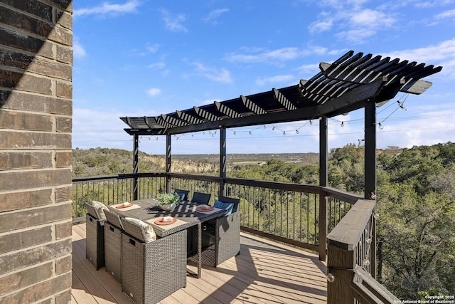 wooden deck with outdoor dining area and a pergola