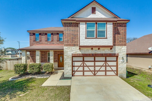 view of front facade with a front yard, fence, concrete driveway, a garage, and stone siding