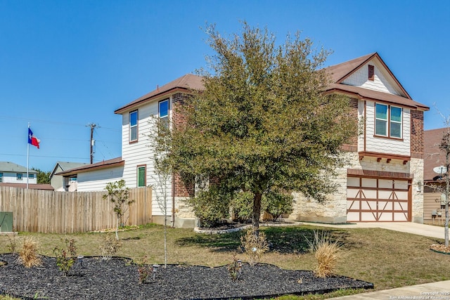 view of front of property featuring fence, a garage, and driveway