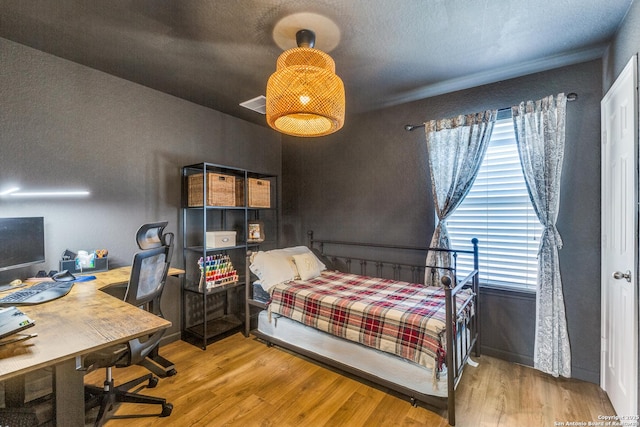 bedroom featuring wood finished floors