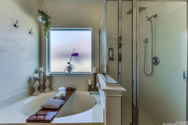 full bath featuring a shower stall and a garden tub