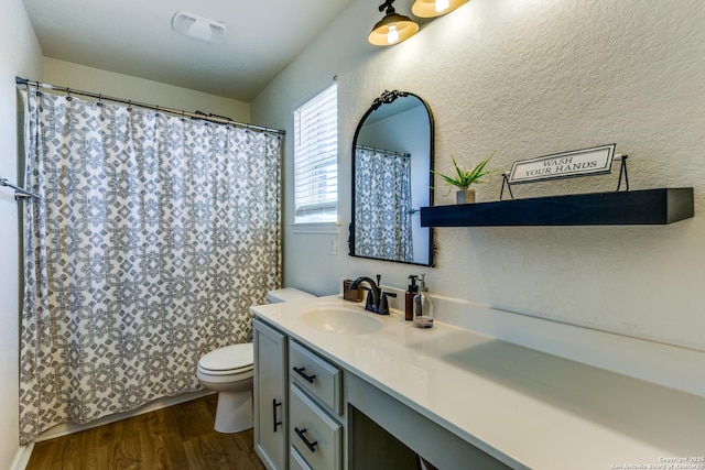 full bath featuring visible vents, toilet, a shower with curtain, wood finished floors, and vanity