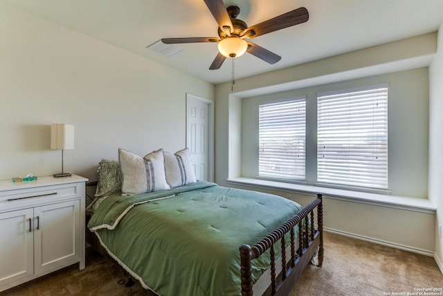 bedroom featuring baseboards, visible vents, dark carpet, and ceiling fan