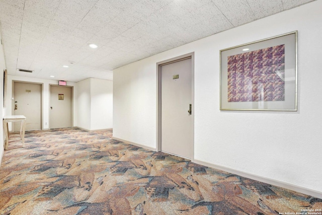 spare room with recessed lighting, visible vents, baseboards, and carpet flooring