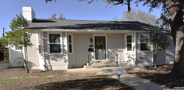 bungalow with crawl space, a chimney, and a shingled roof