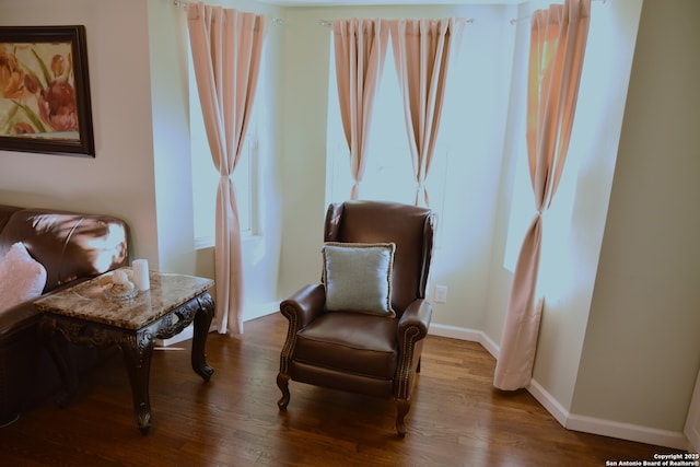 living area featuring wood finished floors and baseboards