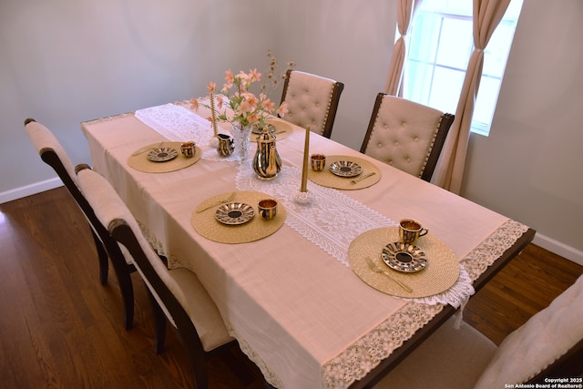 dining area with baseboards and dark wood-style floors