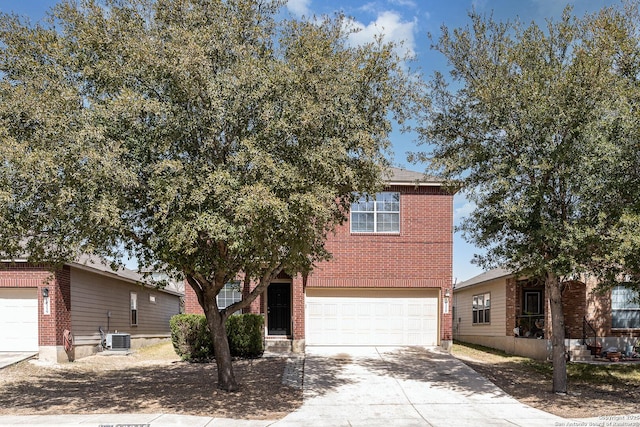 view of front of home with a garage, brick siding, central AC, and concrete driveway