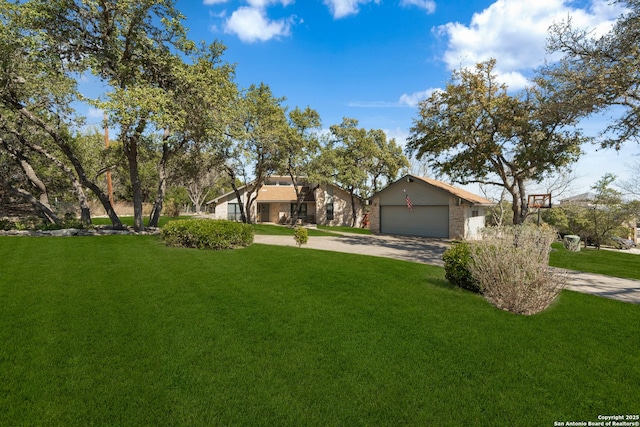 view of front facade featuring brick siding, a garage, a front lawn, and driveway