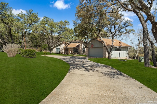 ranch-style house with a front yard, concrete driveway, and an attached garage