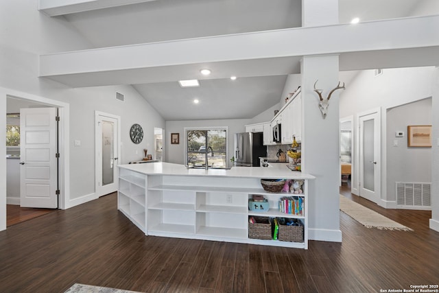 kitchen featuring visible vents, lofted ceiling, appliances with stainless steel finishes, white cabinets, and open shelves