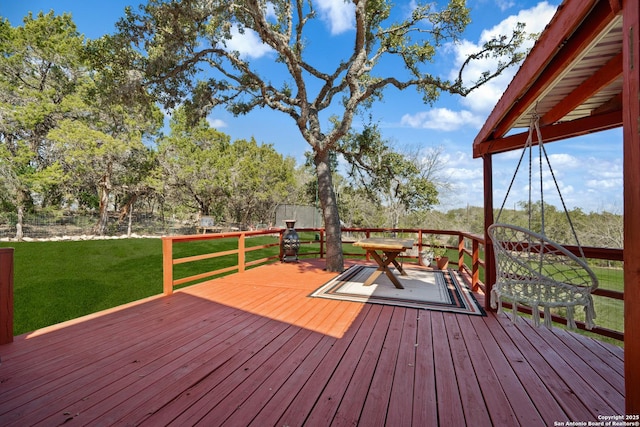 wooden terrace with a yard