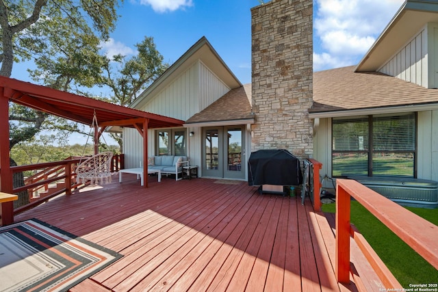 deck featuring french doors and a grill