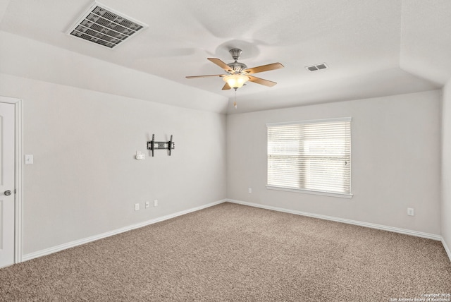 spare room with visible vents, ceiling fan, and carpet floors