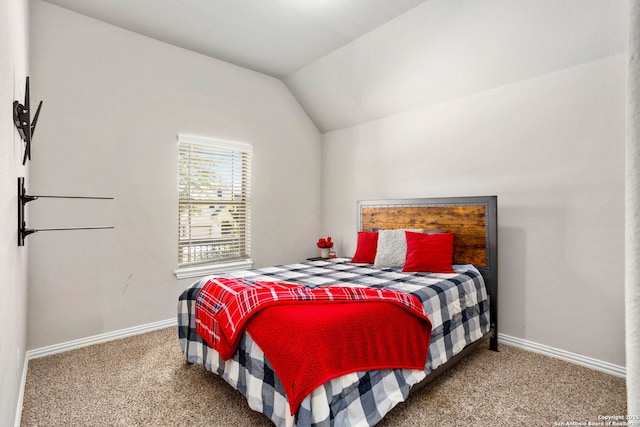 bedroom with baseboards, carpet, and vaulted ceiling