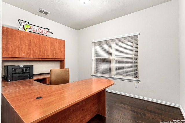 office space with visible vents, baseboards, and dark wood finished floors