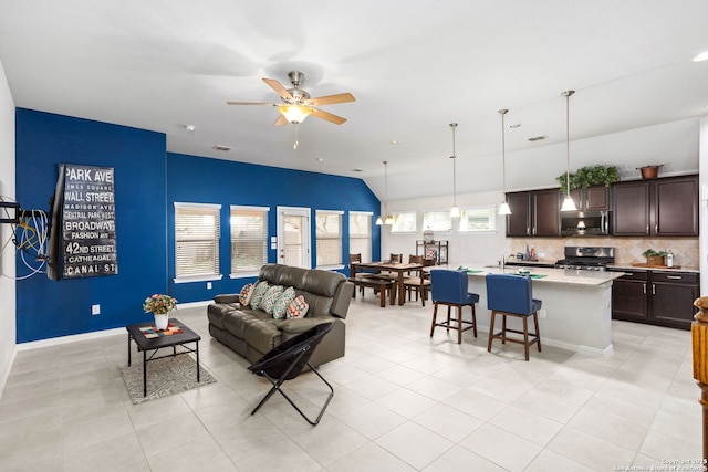 living area featuring light tile patterned floors, visible vents, and a ceiling fan