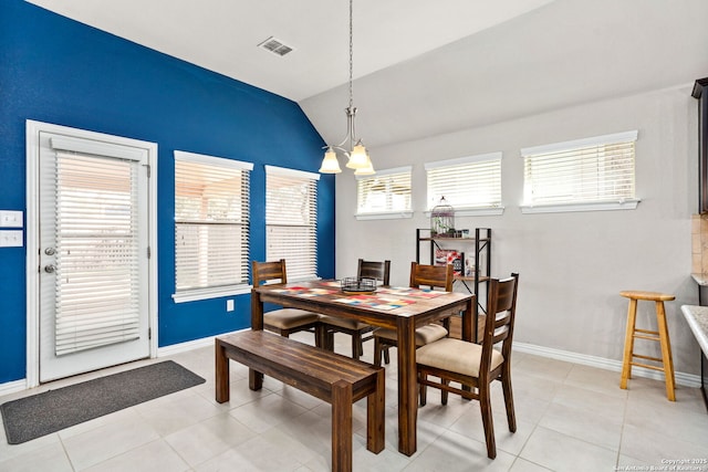 dining room with vaulted ceiling, light tile patterned floors, baseboards, and visible vents