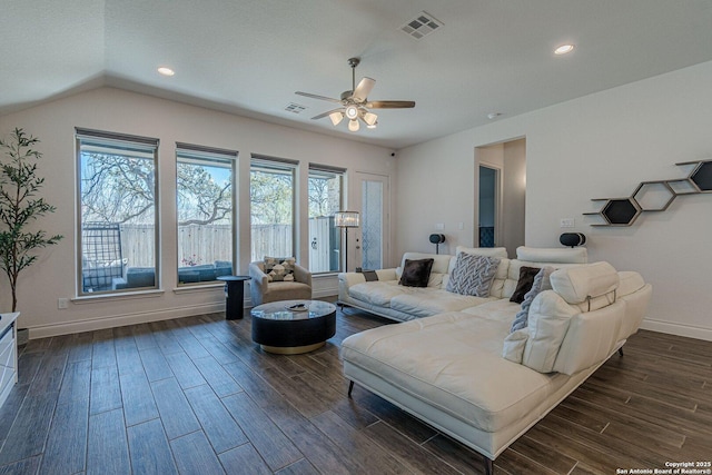 living room with visible vents, baseboards, dark wood finished floors, and a ceiling fan