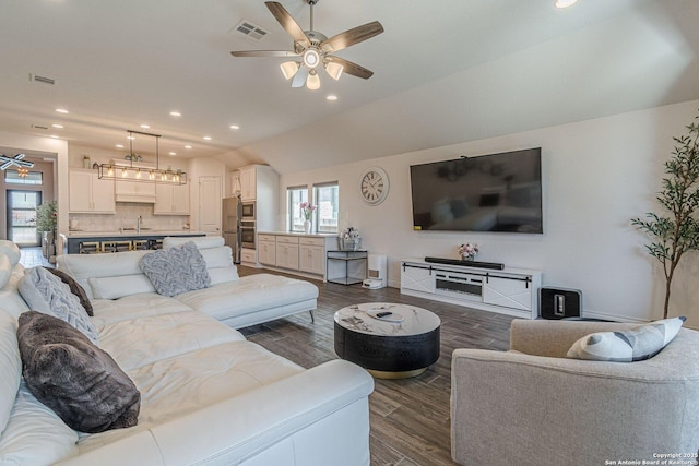 living room with recessed lighting, visible vents, dark wood finished floors, and a ceiling fan