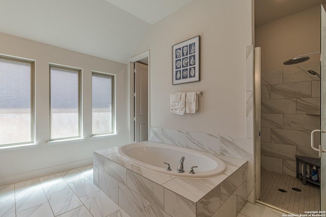 full bathroom featuring a garden tub, a stall shower, and marble finish floor