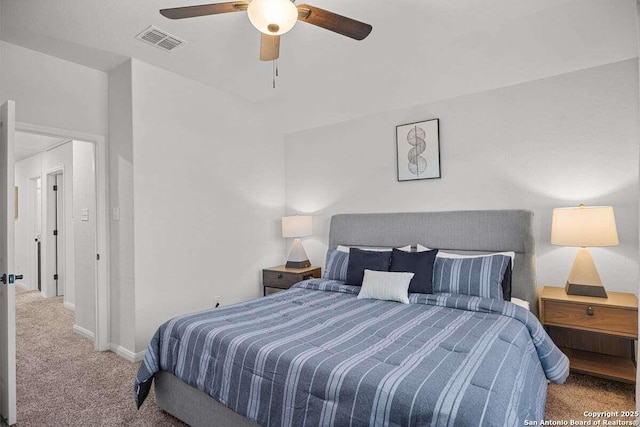 carpeted bedroom with visible vents, baseboards, and a ceiling fan