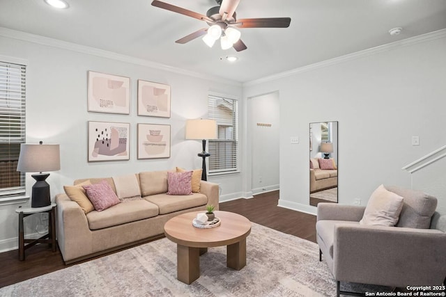 living area with dark wood-type flooring, baseboards, and ornamental molding