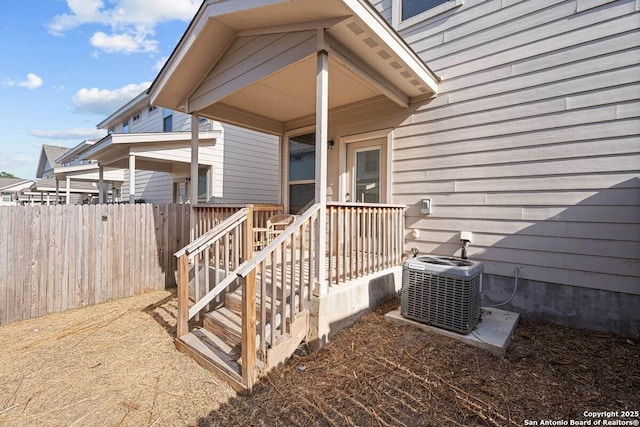 property entrance with cooling unit and fence