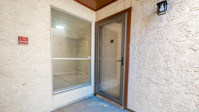 view of exterior entry with stucco siding