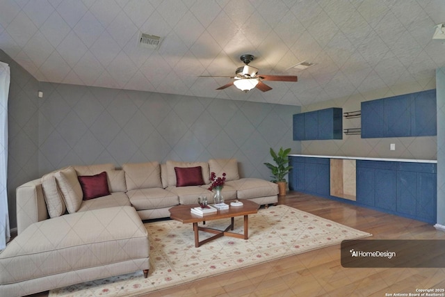 living room with visible vents and a ceiling fan