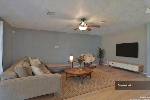 tiled living room featuring visible vents, baseboards, and a ceiling fan