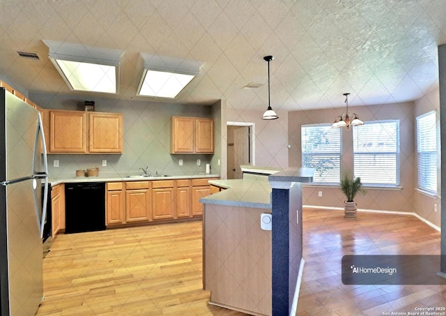 kitchen with visible vents, a sink, freestanding refrigerator, light countertops, and dishwasher