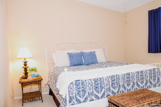 carpeted bedroom featuring baseboards