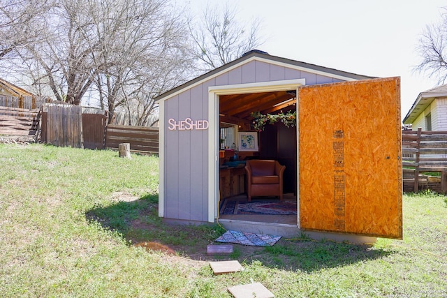 view of outdoor structure with an outbuilding and fence